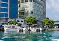 MALE, MALDIVES Ã¢â¬â November, 2017: Three speedboats, standing at the pier, against the background of skyscrapers, Male, Maldives